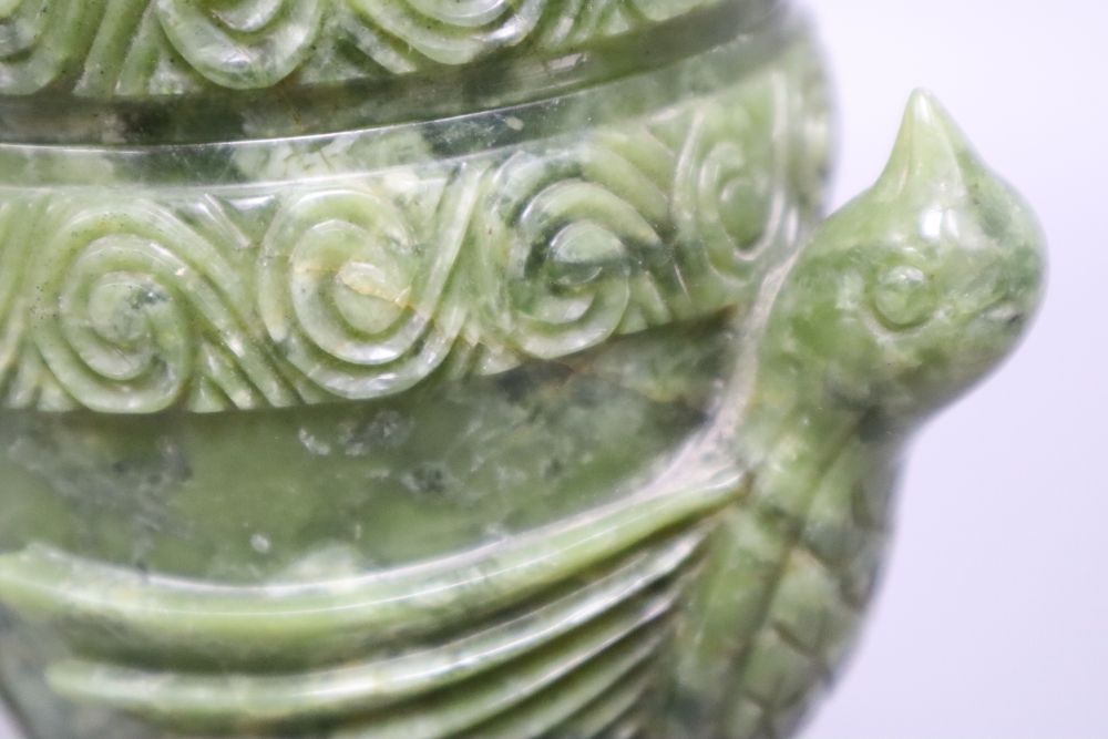 A Chinese green carved hardstone lidded jar, a carved bird group and a plated mirror, tallest 24cm